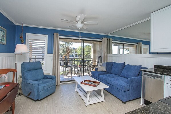 Seaside Villa 232 Living room - Newly renovated condo with all new furnishings, flooring, cabinetry and appliances and a sliding door to the oceanview balcony.