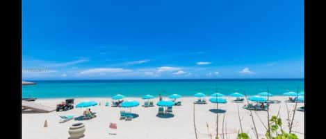 Complementary beach service with umbrellas and lounge chairs.