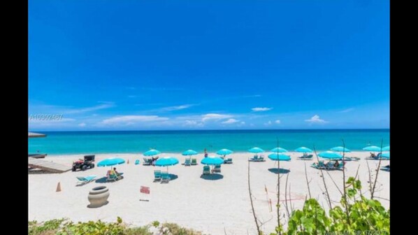 Complementary beach service with umbrellas and lounge chairs.