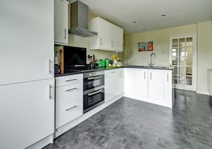 The excellent well equipped kitchen has everything you will need including a breakfast bar