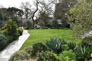 Gorgeous landscaped property. The cottage is off to the left