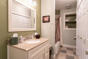 Full bathroom just off of the hallway includes a walk-in shower and beautiful tilework