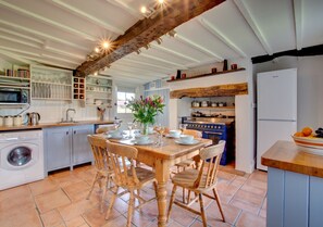 Kitchen with electric range oven table with chairs