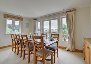 A large separate dining room with French doors also opening to the garden offers a more elegant option for dining