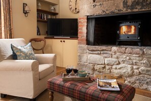 The Smithy, Crookham - enjoy a glass of wine on an evening in front of the TV with the cosy glow of the wood burner
