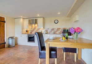 The kitchen is very well equipped and has a dining table for two