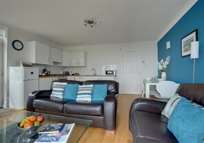 The open plan living area with colourful feature wall