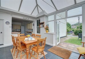 The conservatory leads out onto the patio and garden area