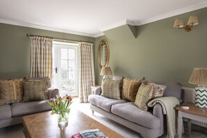 The Wheel House - sitting room with French doors leading out to the patio area and garden