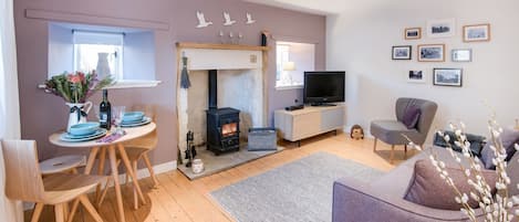 Braemar - sitting room with wood burning stove and dining space for two guests