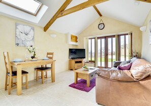 The high apex ceiling and velux windows offer a bright and spacious open plan living space