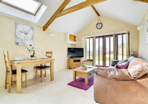 The high apex ceiling and velux windows offer a bright and spacious open plan living space