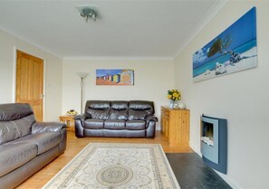 The modern sitting room features comfy leather sofas