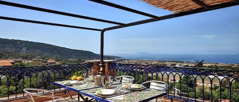 Your large private terrace, with a table and chairs, deckchairs and amazing panoramic views of the Gulf of Sorrento