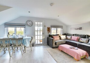 Comfortable corner sofa in the sitting area and dining table to seat 6