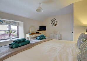 Spacious master bedroom with dressing table and TV