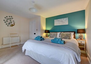 Luxurious superking size bed in the colourful master bedroom