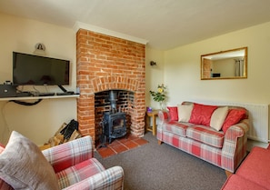 Cosy Sitting Room with comfortable seating, wood burner and TV