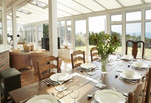 Ground floor: Dining table in the conservatory seating eight guests and seating area