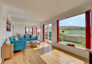 Large picture windows make the most of the bay views in the sitting room