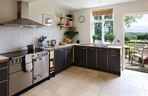 Ground floor:  Kitchen with outside door leading to deck with teak table