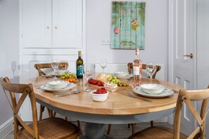 The dining table is extendable and is shown in the image at its largest size. The table will be presented to guests without the middle section on arrival, however, this will be available for guests to extend if required