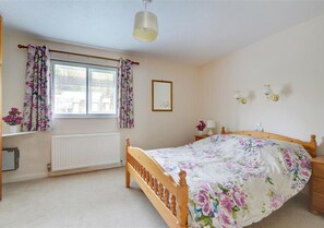 The spacious master bedroom looks over the garden