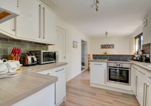 The kitchen/Breakfast Room is modern and bright and benefits from a useful utility room