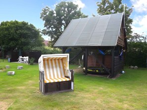 Gartengrundstück mit Gartenmöbeln, Kinderspielzeug, Strandkorb und Lagerfeuerplatz