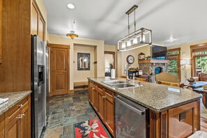 Full size kitchen with stainless steel appliances and granite countertops.