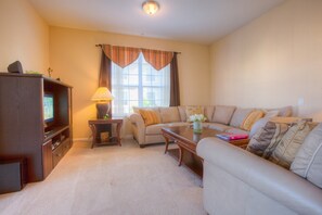 Comfort and Entertainment Meet: Relax in our Inviting Living Room, Perfect for Family Gatherings and Cozy Movie Nights.
