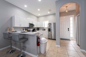 Kitchen showing breakfast bar and entry