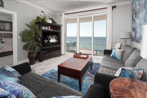 Living room with large screen tv and  lots of DVDs to play.