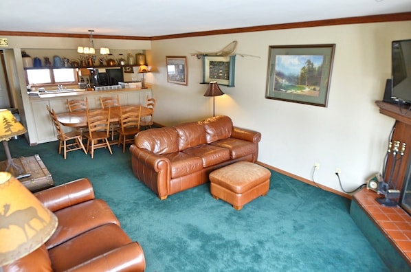 Main Level - The main level has a comfortable living room with a TV, a dining area, a fully equipped kitchen, a back patio with a private hot tub, and a sauna.