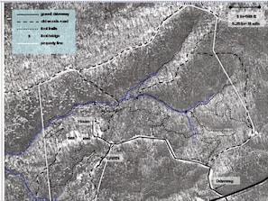Aerial view of property with marked trails