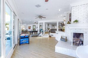 Bright entertainment area with fun for the whole family—pool table, games, and cozy fireplace.