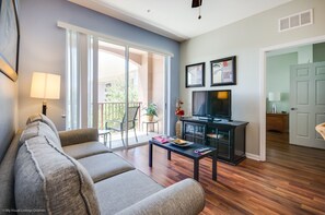Embrace Warmth: Our living room adorned with wooden accent floors exudes a cozy ambiance, inviting you to relax and unwind in the comforting embrace of natural beauty.