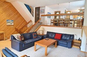 Spacious Living Room Area - The living room is spacious with plenty of sitting space for the entire party. There is a game room table, lots of natural light, a TV, and cozy fireplace.