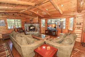 Flat Screen & Wood Burning Fireplace - Living room with entertainment center, cable access and fireplace.