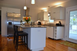 IKEA kitchen with island, bar stools and built-in wine rack