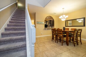 View from entry of stairs and dining area