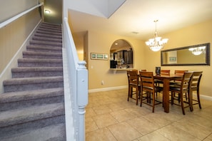 View from entry of stairs and dining area