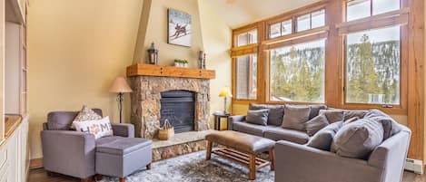 Living area featuring large gas fireplace and sweeping mountain views