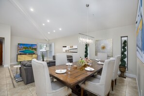 Spacious living and dining area with comfortable seating and vaulted ceilings. 