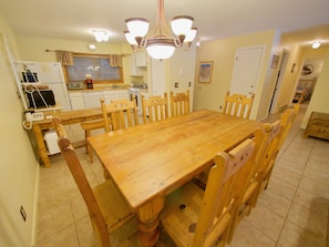 Large Dining and Kitchen Area - The large dining room table is wonderful for the entire party. The dining area opens up into the fully equipped kitchen and living room.