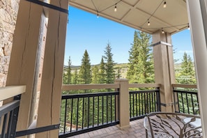 Private balcony with outdoor seating, fun hanging lights and incredible views.