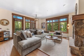 The living area features a flat screen TV, a gas fireplace and a queen-sized sleeper sofa.
