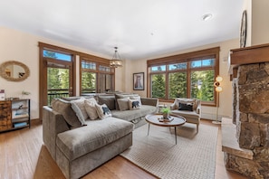 The living area features a flat screen TV, a gas fireplace and a queen-sized sleeper sofa.