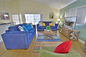 Living room showing seating overlooking the pool area