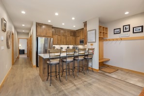Kitchen, breakfast bar, and entryway